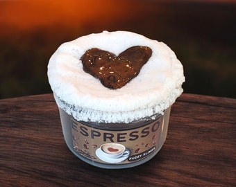 May include: A clear jar of fluffy slime with a brown heart-shaped design on top. The jar has a label that says "Espresso" and "Fuzzy Slime".