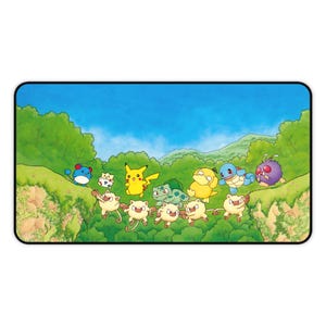 May include: A rectangular playmat featuring a colorful illustration of various Pokémon characters including Pikachu, Bulbasaur, Squirtle, Psyduck, and Mankey, set against a vibrant green forest landscape under a clear blue sky.