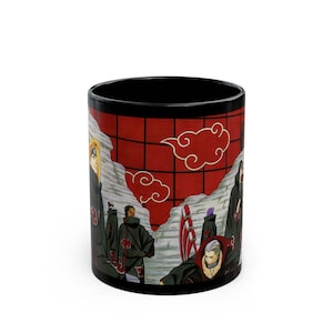 May include: Black ceramic mug with a red and white cloud design and a group of characters in black cloaks. The mug has a black interior and a white background. The design is inspired by an anime series.