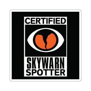 May include: A black and white sticker with the text "CERTIFIED SKYWARN SPOTTER" and a stylized eye with an orange, cracked heart inside.