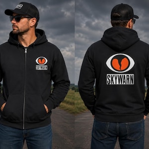 May include: A black zip-up hoodie featuring a white oval logo with an orange cracked heart graphic and the text SKYWARN printed in white on the left chest and in a larger version on the back. The hoodie includes a hood and two front pockets.