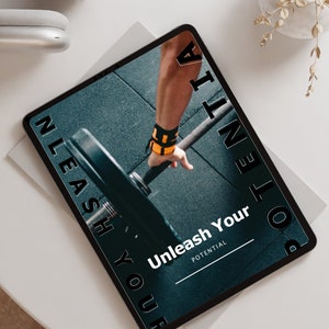 May include: A tablet computer displaying a motivational quote, "Unleash Your Potential", with a photo of a person lifting weights in a gym. The text is in black and white, and the background is a dark blue.