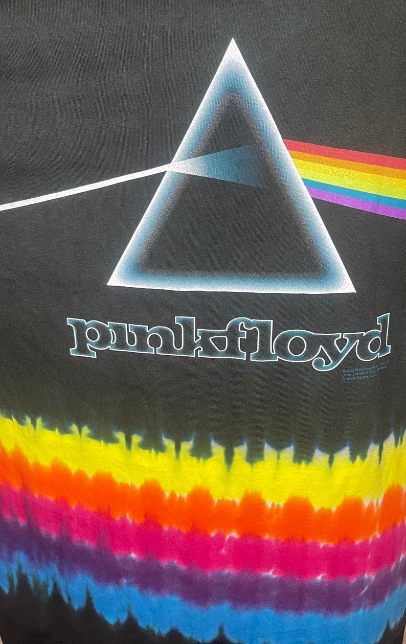 May include: Black tie-dye t-shirt with a white triangle and rainbow prism graphic. The text "pink floyd" is printed below the graphic.
