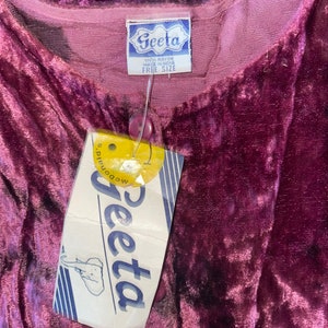 May include: A purple velvet robe with a white tag that says "Geeta 100% Rayon Made in India Free Size".