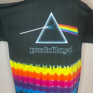 May include: Black tie-dye t-shirt with a rainbow prism and a triangle graphic. The text "pink floyd" is printed below the graphic.