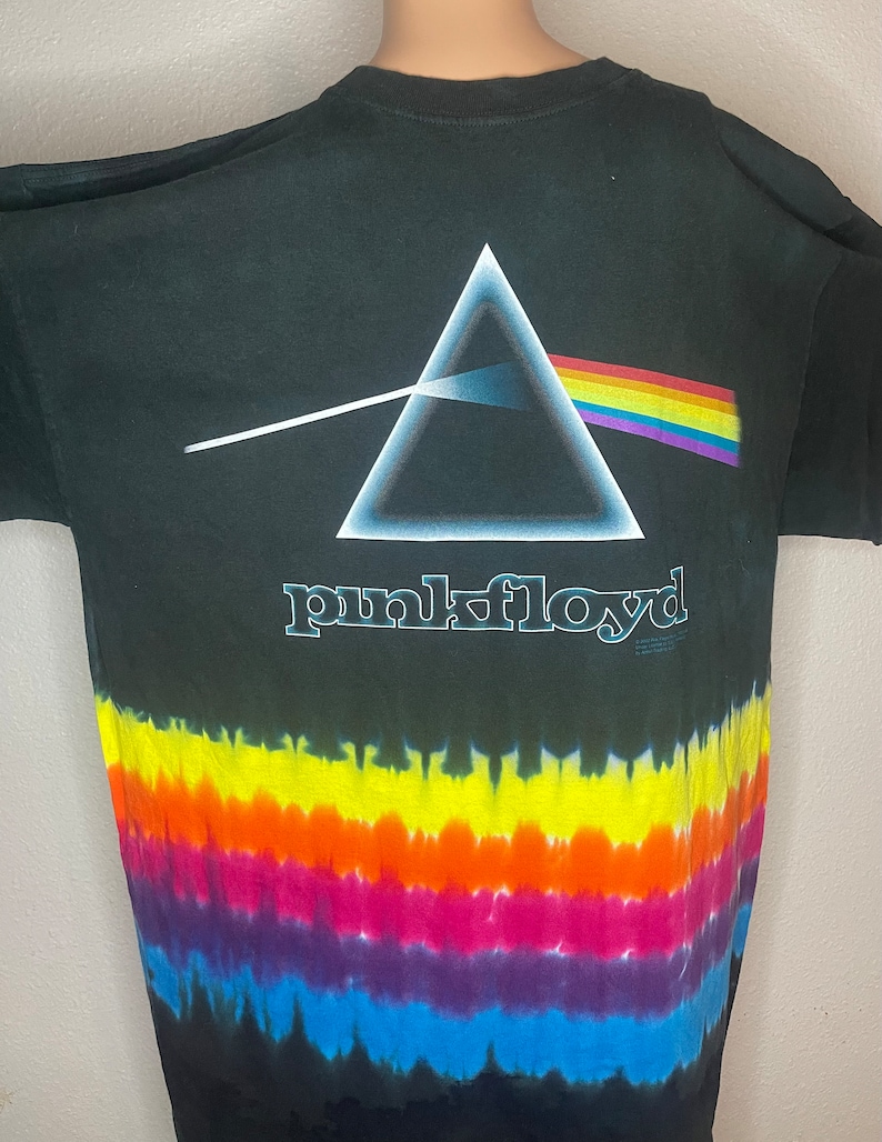 May include: Black tie-dye t-shirt with a rainbow prism and a triangle graphic. The text "pink floyd" is printed below the graphic.