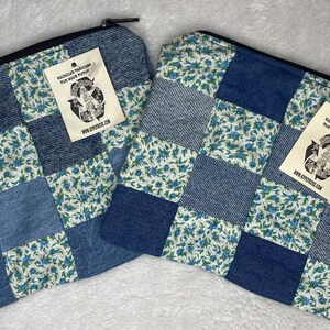 May include: Two blue and white patchwork zippered pouches with a tag that reads "Recycled fashions for your future" and the website www.etsy.com/shop/ecostyleco.