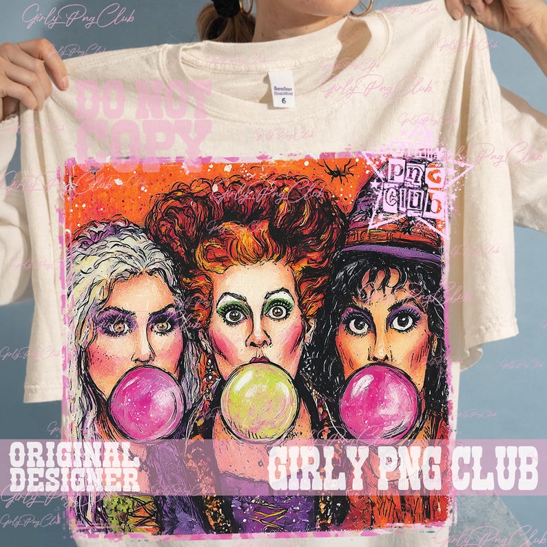 May include: A cream-colored t-shirt featuring a graphic print of three women with distinct hairstyles, each blowing a bubble with gum. The central figure has red hair, while the others have blonde and dark hair, all set against an orange background.