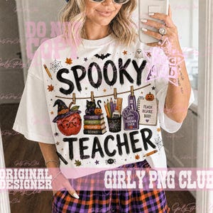 May include: A white t-shirt featuring the text SPOOKY TEACHER and a graphic print of a black cat on books, a pumpkin with glasses, a pencil cup, and a foam finger. The design includes Halloween elements like a bat, spider, and ghost.