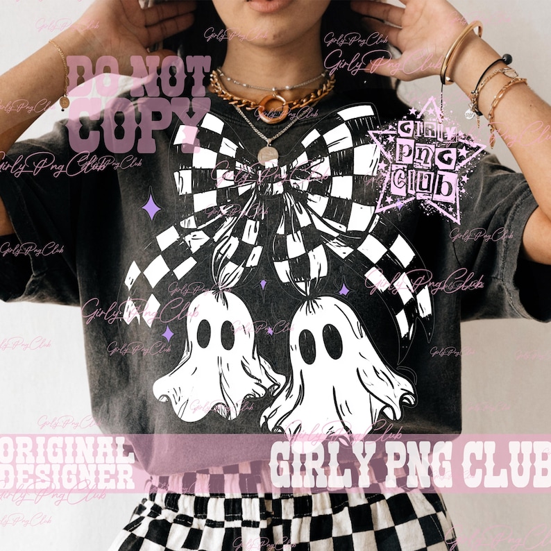 May include: A charcoal gray mineral wash t-shirt featuring a large white graphic of a checkered bow tied above two ghosts. The design includes small purple stars and the text GIRLY PNG CLUB inside a star shape. The shirt has a crew neckline.