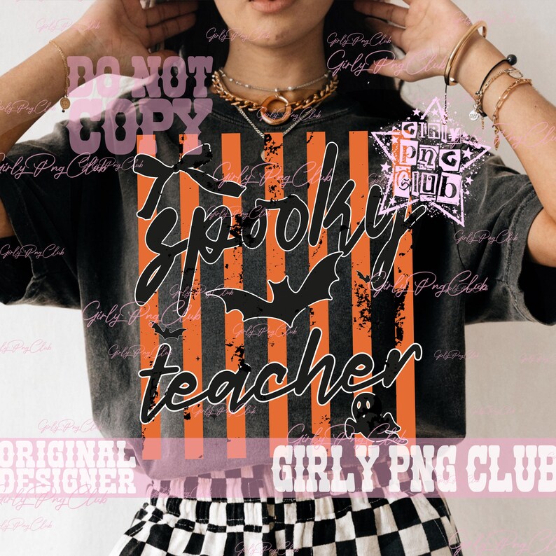 May include: A black t-shirt featuring a graphic with vertical orange and black stripes, a black bow, a black bat silhouette, and a small ghost. The text reads spooky teacher in a cursive font. The design has a distressed, weathered texture.