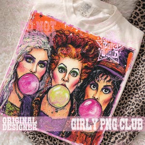 May include: A cream-colored t-shirt featuring a graphic illustration of three women with distinct hair colors&mdash;blonde, red, and black&mdash;each blowing a large bubble with gum. The design includes a star-shaped logo with the text PNG CLUB.