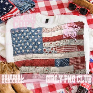 May include: White sweatshirt with a patchwork American flag design. The flag uses blue, red, and white fabrics with star and stripe patterns. The sweatshirt has a crew neck and long sleeves, suitable for patriotic occasions.