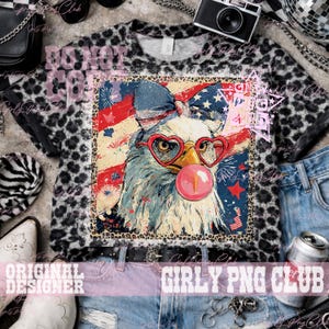 May include: A cropped t-shirt with a leopard print pattern and a graphic of an eagle wearing heart-shaped glasses and blowing a bubble. The eagle is set against a backdrop of the American flag. The text "DONOT COPY" is visible on the shirt.
