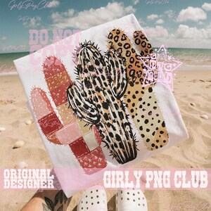May include: White t-shirt featuring a cactus design with leopard print and patchwork elements. The design includes the text "DO NOT COPY" and "ORIGINAL DESIGNER GIRLY PNG CLUB". The shirt is displayed on a sandy beach.