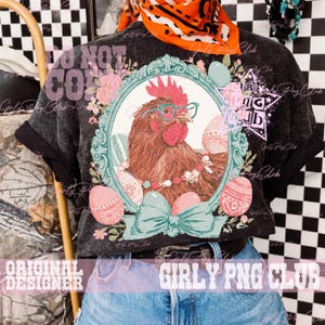 May include: Dark gray t-shirt featuring a framed illustration of a chicken wearing glasses and a pearl necklace, surrounded by Easter eggs and flowers. The shirt has rolled-up sleeves and the text "DO NOT COPY" and "GIRLY PNG CLUB".