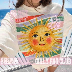 May include: Cream-colored t-shirt featuring a smiling sun graphic with a face, surrounded by yellow rays. The shirt has a striped background in various colors and the text "SUMMER" and "GIRLY PNG CLUB".