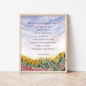 May include: A watercolor painting of a field of flowers with a quote from Ephesians 2:4. The quote reads: "But God being rich in mercy because of the great love with which he loved us even when we were dead in our trespasses made us alive together with Christ."