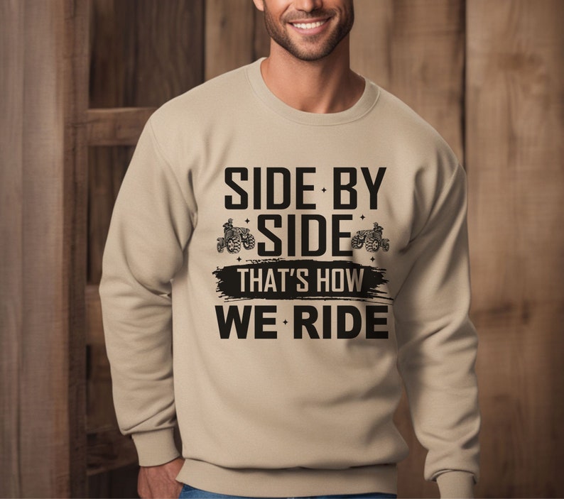 May include: Tan sweatshirt with black text that reads "Side by Side That's How We Ride" with a graphic of two side-by-side vehicles.