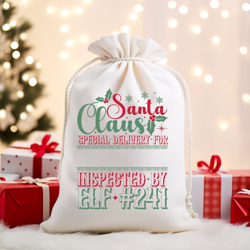 May include: White canvas gift bag with red and green text that reads "Santa Claus Special Delivery For" and "Inspected By Elf #241".