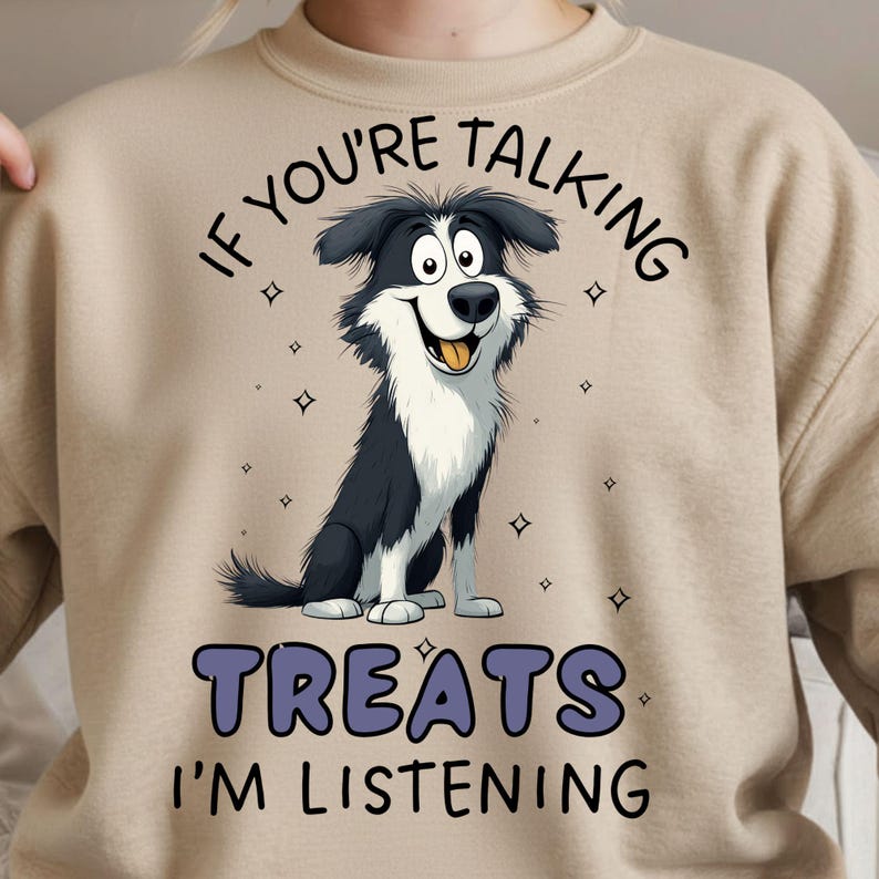 May include: Beige sweatshirt with a cartoon illustration of a black and white Border Collie dog. The text above the dog reads "IF YOU'RE TALKING" and below the dog it says "TREATS I'M LISTENING".