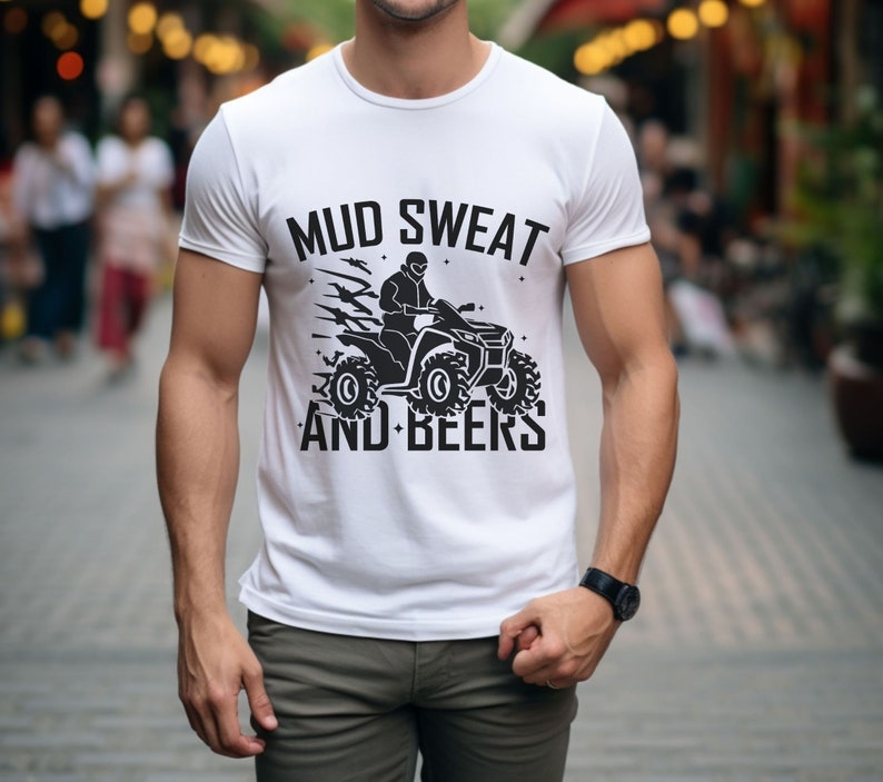 May include: White t-shirt with a black graphic of a person riding an ATV with the text "MUD SWEAT AND BEERS".