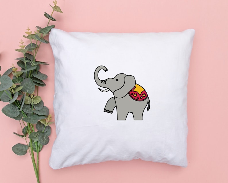 May include: White pillowcase with a cartoon illustration of a gray elephant wearing a red and yellow circus costume.