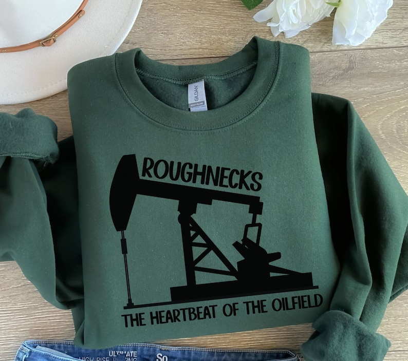May include: A dark green sweatshirt with a black silhouette of an oil derrick and the text "Roughnecks The Heartbeat of the Oilfield".