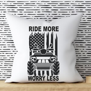 May include: White pillow with a black and white graphic of an ATV with an American flag in the background. The text "Ride More Worry Less" is printed below the ATV.