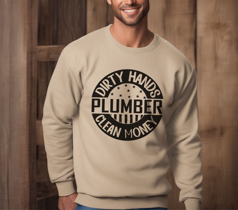 May include: Tan sweatshirt with a black circle graphic that says "Dirty Hands Plumber Clean Money".