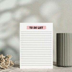 May include: A white to-do list with a pink "TO DO LIST" banner at the top. The list has black lines for writing and colorful dots on the left side.
