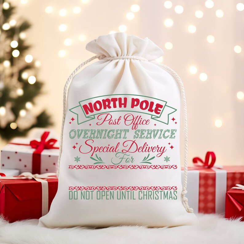 May include: White canvas gift bag with red and green text that reads "North Pole Post Office Overnight Service Special Delivery For" and "Do Not Open Until Christmas".