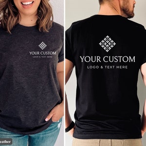 May include: Dark grey heather and black t-shirts with a white diamond-shaped logo and the text "YOUR CUSTOM LOGO & TEXT HERE." The shirts are short-sleeved and suitable for custom branding or personal designs.