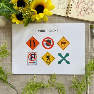 May include: A white sheet of paper with the words "PUBLIC SIGNS" printed at the top. There are seven different traffic signs printed on the sheet, including a no parking sign, a pedestrian crossing sign, and a do not honk sign.