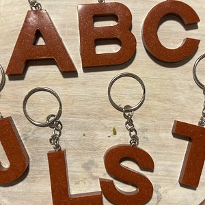 Llaveros con letras de cobre brillante