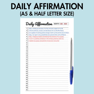 May include: A printable daily affirmation journal with a blue pen. The journal has a white background with black lines and numbers 1 through 31. The text at the top of the page reads "Daily Affirmation" and "MONTH: DEC, 2023".
