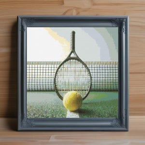 May include: Framed artwork featuring a tennis racket and ball on a green court, positioned in front of a net. The artwork is in a gray frame and set against a light background. The tennis ball is yellow.
