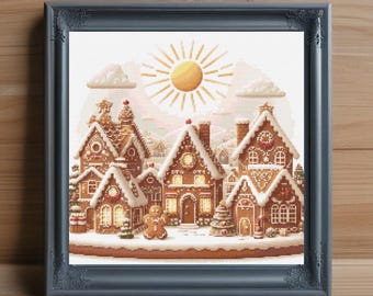 May include: Framed cross-stitch art featuring a gingerbread village scene with snow-covered rooftops, a gingerbread man, and a bright yellow sun. The artwork is set against a light background and framed in a dark gray frame.
