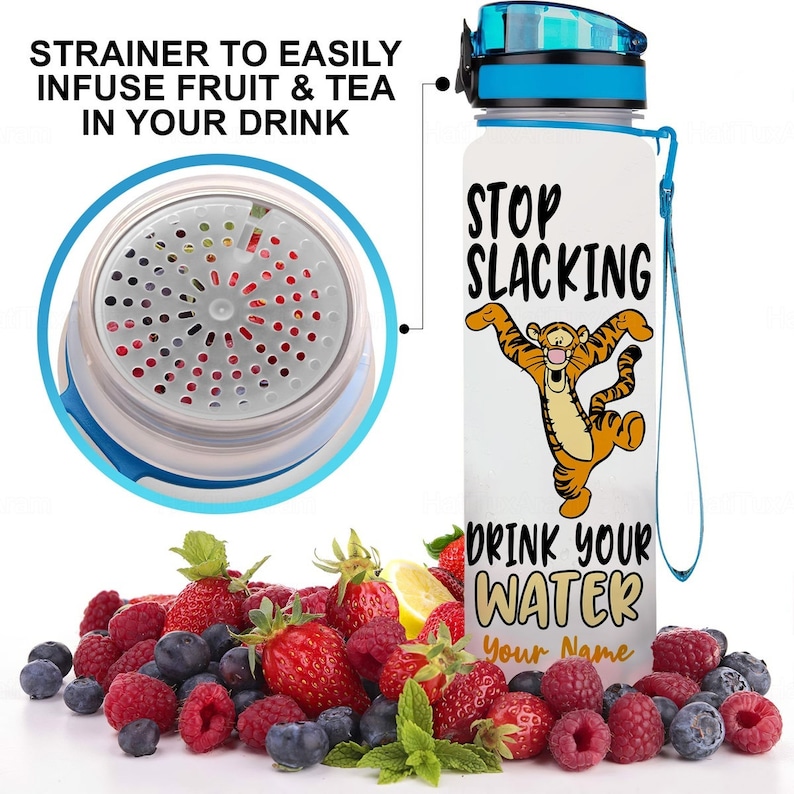 May include: White water bottle with a blue lid and a blue carrying strap. The bottle has a graphic of a cartoon tiger with the text "Stop Slacking Drink Your Water Your Name". The bottle has a strainer to infuse fruit and tea.