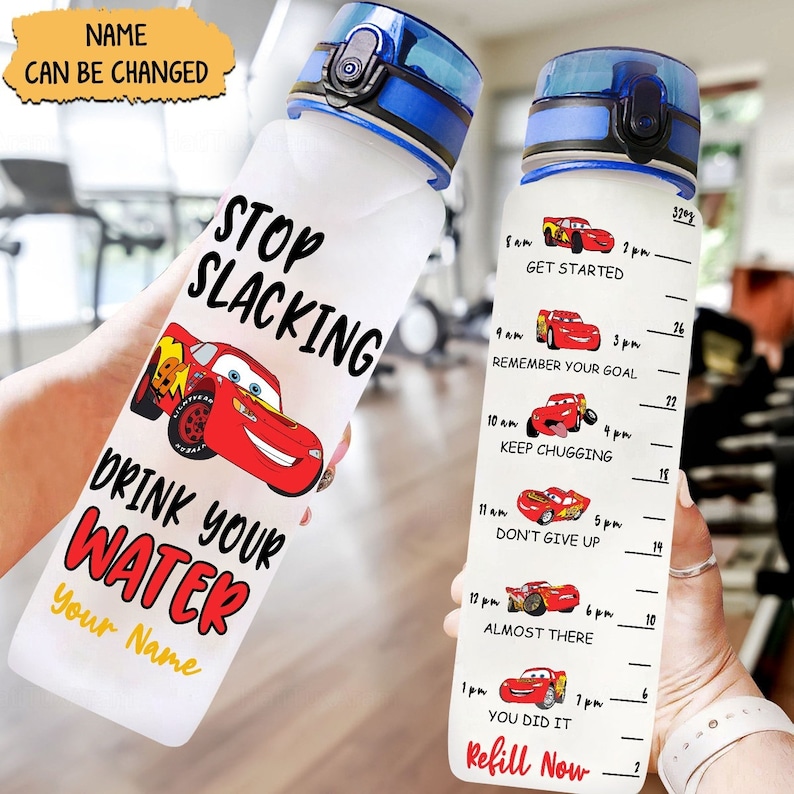 May include: A clear water bottle featuring a red Lightning McQueen character from the Disney Pixar film Cars. The bottle has a blue lid and a motivational quote that reads "Stop Slacking Drink Your Water". The bottle also includes a time-based motivational chart with the text "Get Started", "Remember Your Goal", "Keep Chugging", "Don't Give Up", "Almost There", "You Did It", and "Refill Now".