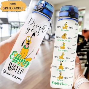 May include: A white water bottle with a green and white graphic that says "Drink your effing water" and a cartoon image of Pluto. The bottle has a blue lid and a measurement scale on the side with times and motivational phrases. The scale is marked in ounces.