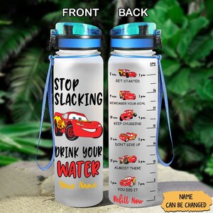 May include: A clear plastic water bottle with a blue lid and a red and black cartoon car graphic. The bottle has a motivational quote that says "Stop Slacking Drink Your Water" and a space for a name. The back of the bottle has a motivational quote for each hour of the day with a cartoon car graphic.