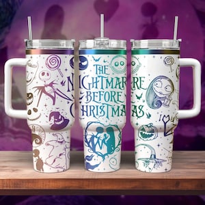 May include: Three stainless steel tumblers with a white background and colourful designs featuring characters from the movie The Nightmare Before Christmas. The tumblers have a handle and a lid with a straw.