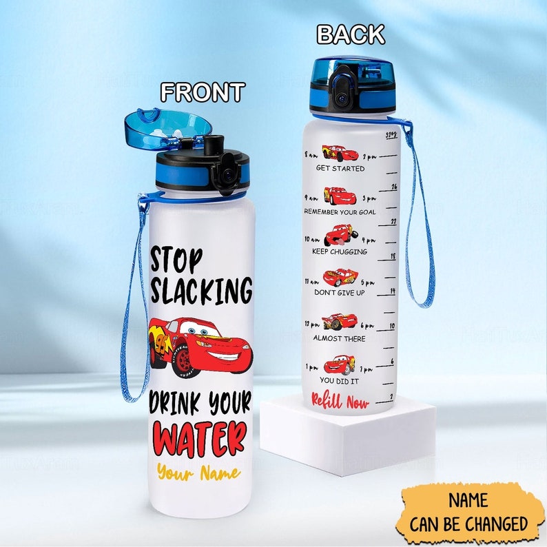 May include: A white water bottle with a blue lid and strap. The bottle has a red cartoon car on the front with the text "Stop Slacking Drink Your Water Your Name". The back of the bottle has a motivational quote with a red cartoon car for each hour of the day.