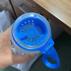 May include: A blue and white water bottle with a built-in strainer and a blue carrying strap.