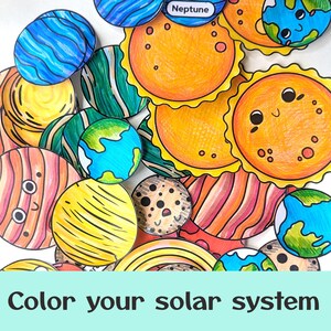 May include: A collection of hand-colored paper cutouts depicting planets and the sun with cartoon faces. The celestial bodies feature vibrant markers in shades of orange, yellow, blue, green, and pink. One cutout is labeled Neptune. The text reads Color your solar system.