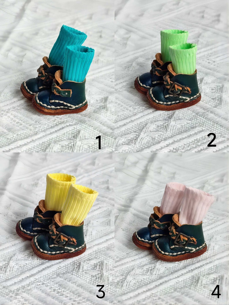 May include: Four pairs of miniature leather boots with different colored socks. The boots are dark blue with brown leather accents and laces. The socks are turquoise, light green, yellow, and pink.