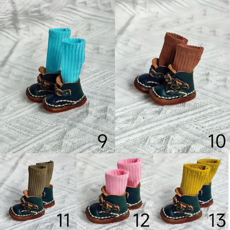 May include: Ten pairs of miniature leather boots with different colored socks. The boots are dark blue with white stitching and have a buckle detail. The socks are blue, brown, pink, and yellow.