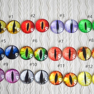 May include: Twelve pairs of glass eyes with different colors and patterns, including yellow, red, green, blue, purple, and black. Each pair is numbered 1 through 12.
