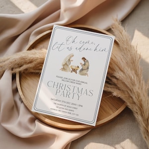 May include: A rectangular Christmas party invitation with a white background and a navy blue border. The invitation features the text "Oh come, let us adore him" and "Christmas Party". It includes an illustration of the Nativity scene.